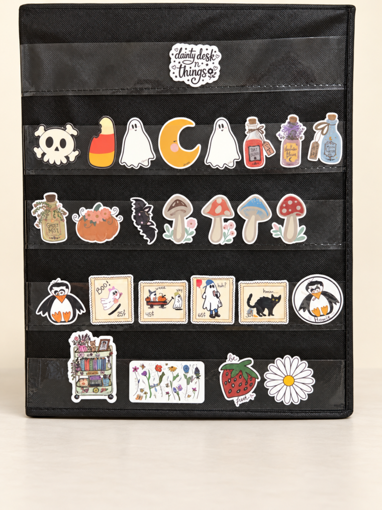 Hand-drawn Halloween, mushroom, floral and reading-themed stickers on a black display.
